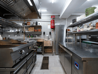 Modern stainless-steel kitchen setup illustrating the build vs rent central kitchen decision for food business owners.
