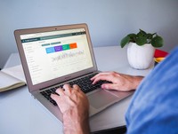 The laptop screen displays a web browser window open to Google Search Console, specifically showing the "Performance" report dashboard.