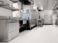 Modern stainless steel kitchen setup with ample space, ideal for guides on how to secure a commercial kitchen lease.